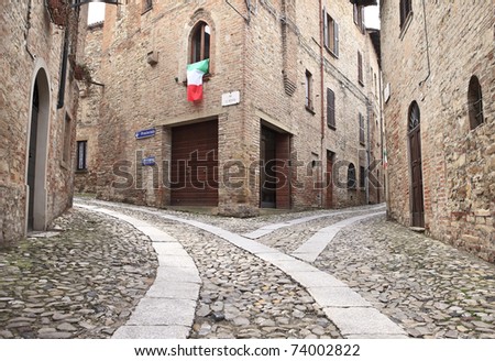 Old terraced houses on cobbled alleyway, Castell'Arquato, Italy