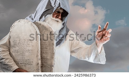 The Old Testament prophet Moses holds tablets with ten  commandments on a white background