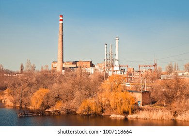 An old thermoelectric power station on the river on a sunny day