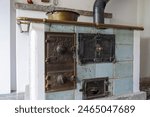 An old tiled kitchen oven for wood heating in a historic old farmhouse from 1728