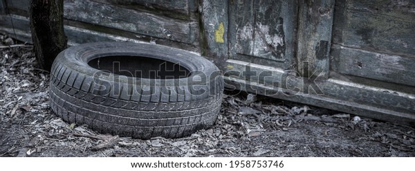 Old tire near the\
old door at the junkyard