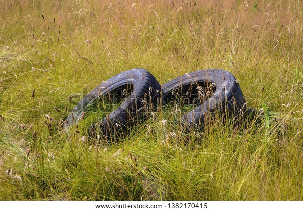 Old\
tires dumped on a meadow in Mazovia region of\
Poland