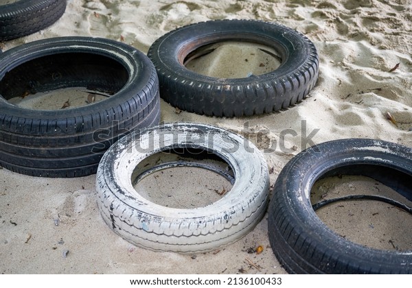 Old tires for\
people to play with on the\
beach