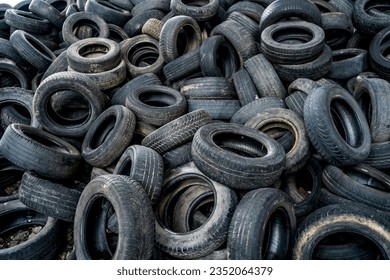 Old tires trash storage. Used tires at recycling garbage field. - Shutterstock ID 2352064379
