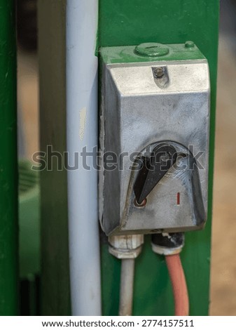 Old toggle switch for a motor on a machine.