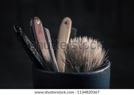 Old tools for barber. Sharp razor, soap and brush
