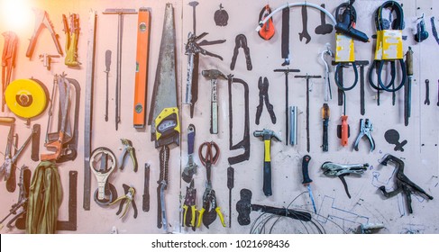 Old tools hanging on wall in workshop.Something's gone. Tools concept - Shutterstock ID 1021698436