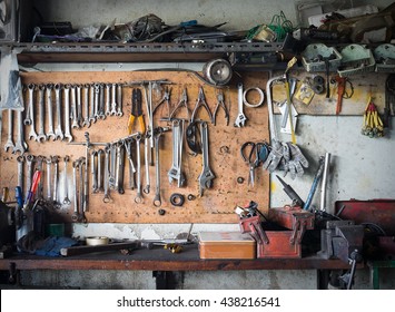 Old Tools Hanging On Wall In Workshop , Tool Shelf Against A Wall