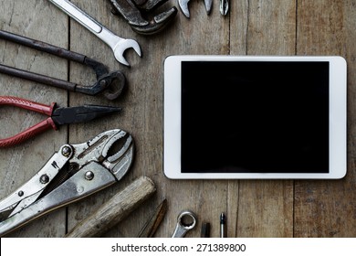 Old Tools And Tablet On A Wooden Table