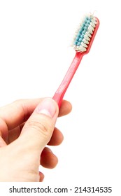 Old Toothbrush In Hand Isolated On White Background