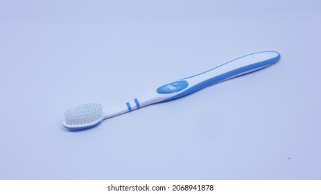 An Old Toothbrush Isolated On A White Background       