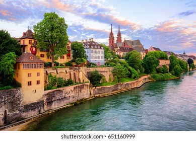The Old Town of Basel with red stone Munster cathedral and the Rhine river, Switzerland, in dramatic sunset light