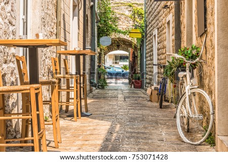 Old Town  Budva, Montenegro. The first mention of this city - more than 26 centuries ago. We see ancient houses, a very narrow street, cafes, shops.