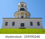Old town clock in Halifax, Nova Scotia on green lawn with blue sky.