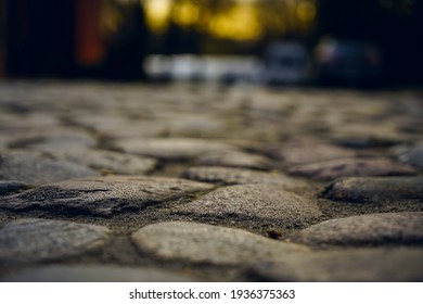 Old town in Europe at sunset with retro vintage cobble stone. cobble paving Stones background for walking.