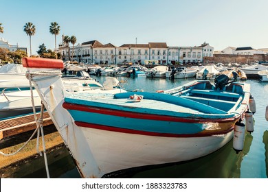 Old town of Faro with traditional wooden boat moored in marina, Algarve, Portugal