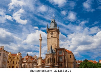 Old Town Hall medieval clock tower among clouds in Prague, a city landmark erected in 1364 in Old Town Square, with Marian Column