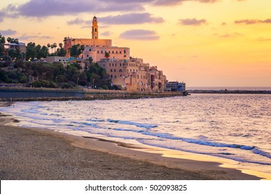 Old town of Jaffa over the sand beach bay on sunset, Tel Aviv, Israel