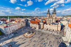 Old Town Of Prague, Czech Republic. View On Tyn Church And Jan Hus Memorial On The Square As Seen From Old Town City Hall. Blue Sunny Sky