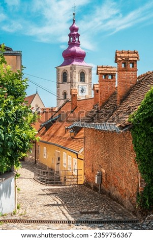 Old town of Ptuj, path to castle, view over St. George's church belltower, Ptuj, Slovenia