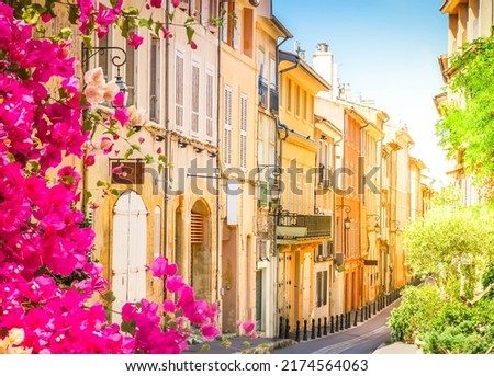 old town street with flowers of Aix en Provence, France, toned