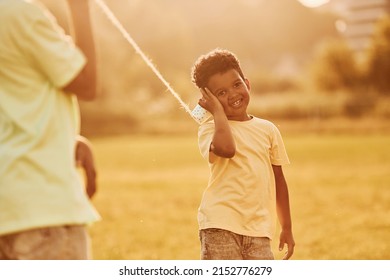 Old Toy Phone. Two African American Kids Have Fun In The Field At Summer Daytime Together.