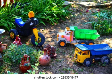 Old Toy Trucks In The Yard Of A House