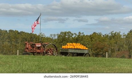 Old tracker pulling trailer full of pumpkins.