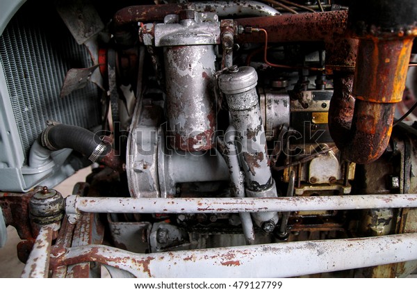 Old tractor engine with many\
modifications. Rusty, but working. Old agricultural\
machine.