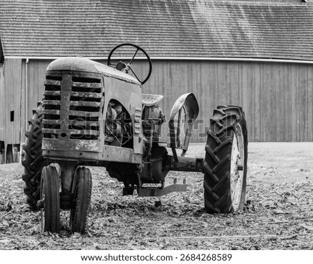 old tractor in front of a barn
