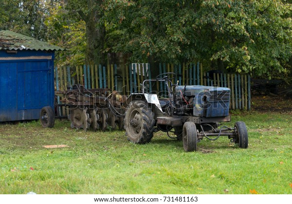 Old tractor on a background of sky, yard
machine, Agriculture