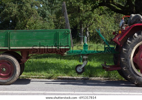 old tractor in red and green color with details of
motor engine and tools