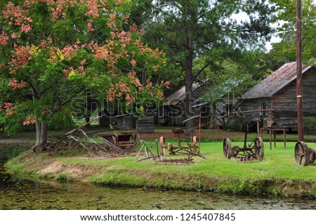 Old tractors and cabinds in Acadian Village