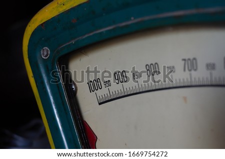 Old trade analog scales. Fragment of a metal scale with a red arrow. Digital scale with numbers. Close-up. Selective focus.