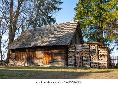 Old traditional Estonian farm house, shed and barn. Weathered old countryside buildings. construction materials- timber,logs, wood, stone, rocks. Location near Tartu, Estonia, Europe. Well kept