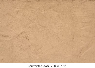 Old traditional house wall texture. Brown beige sandy color rough plaster background.