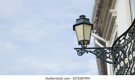 An Old Traditional Iron Gas Light Street Lamp On A Building In Faro, Algarve, Portugal