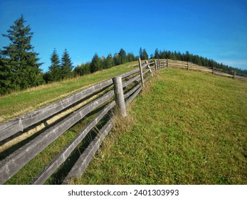 Old traditional rustic fence in the field