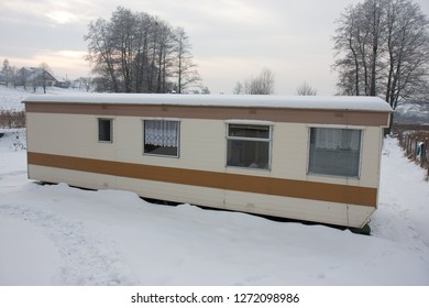 Old Trailer In Snowy Park