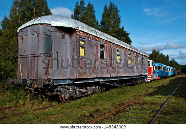  Old\
trains in abandoned rail yard in summer\
evening