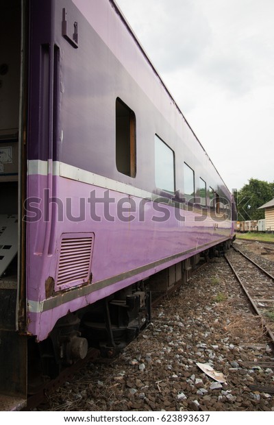 Old\
trains are parked outdoors where they are exposed to the heat of\
sunlight and rain, resulting in cracking and\
rusting.