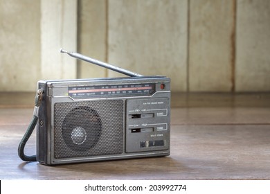 Old Transistor Radio On Wooden Background.