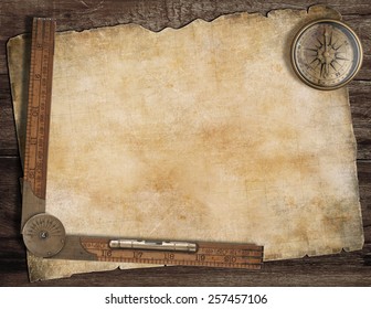 Old treasure map background with compass and wood ruler. Exploration concept.