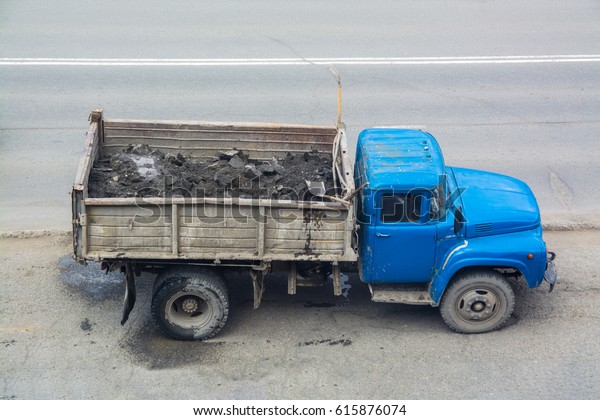 Old truck with a\
blue cabin. Top side view.
