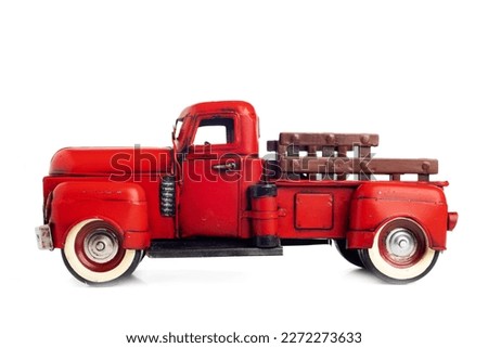 Old truck close-up. Red, vintage, toy truck isolated on white background.