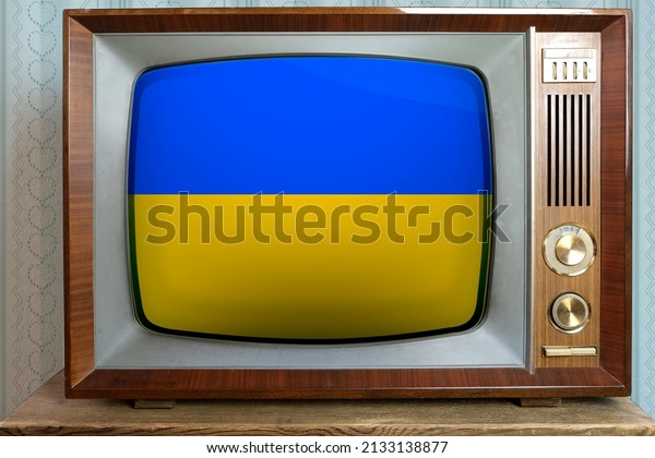 old tube vintage TV with the national flag of\
Ukraine on the screen, stylish interior of the 60s, the concept of\
eternal values ​​on television, global world trade, politics, retro\
technologies, news