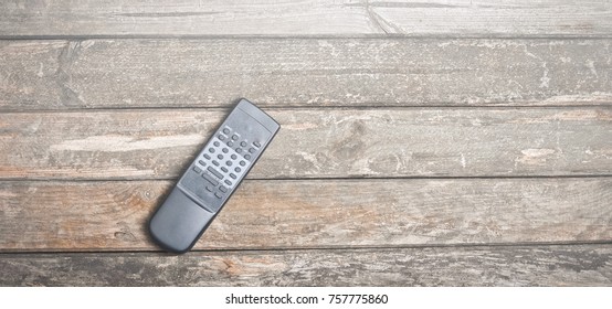 Old Tv Remote On A Wooden Rustic Table. Top View.