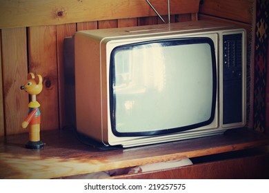 Old  tv. Retro style. Old household wooden background