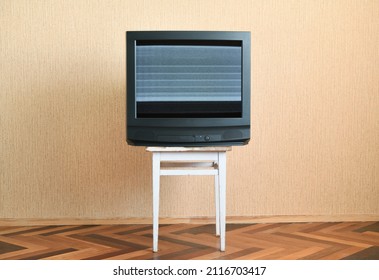 Old TV With Screen Noise And Interference On An Old Chair, Old House Design In 1980s And 1990s Style.