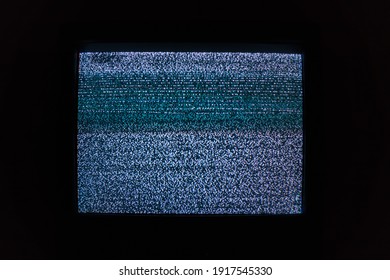 Old TV Screen With Noisy Image Due To Lack Of TV Signal In Dark Room